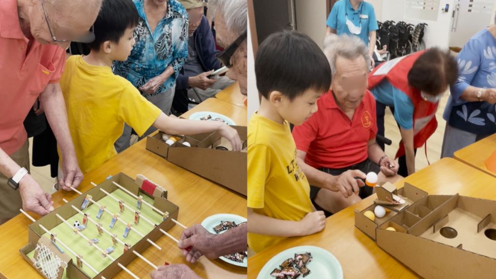 Benjamin’s station: handmade cardboard foosball and a ping pong ball catapult, built from recycled materials
